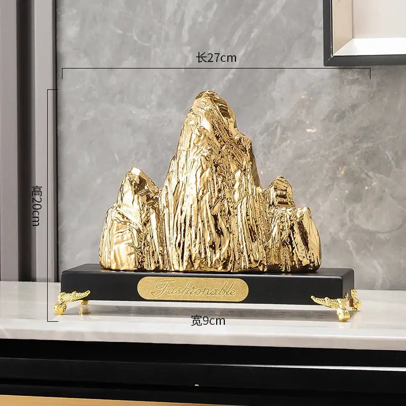 Modern gold and silver decorbites ceramic mountain sculpture with textured gold finish and black base for living room decor