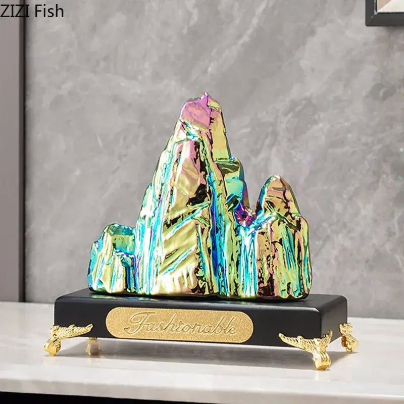 Modern gold and silver decorbites ceramic mountain sculpture with iridescent finish on ornate black base for living room decor