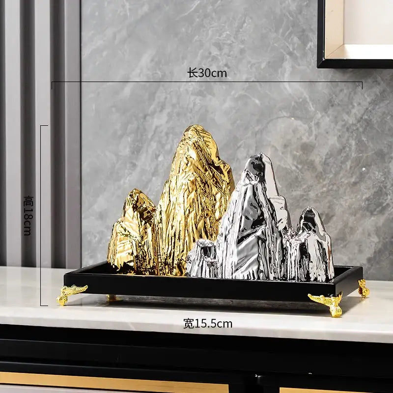 Modern gold and silver ceramic mountain sculpture with metallic finish on black tray with gold feet for living room decorbites ceramic mountain decor