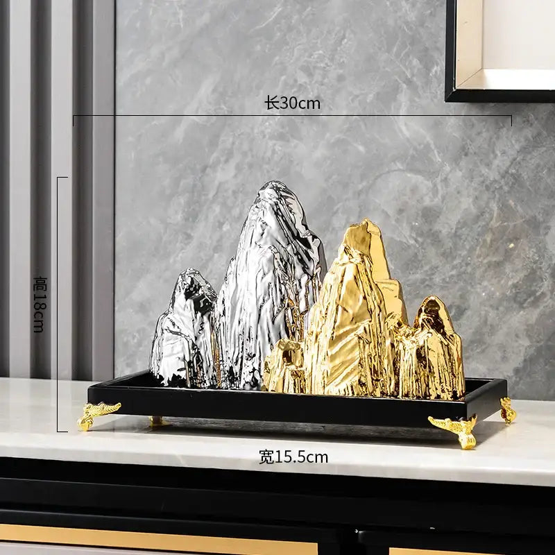 Set of five metallic silver and gold ceramic mountain sculptures on black tray with golden feet for modern decorbites ceramic mountain decor