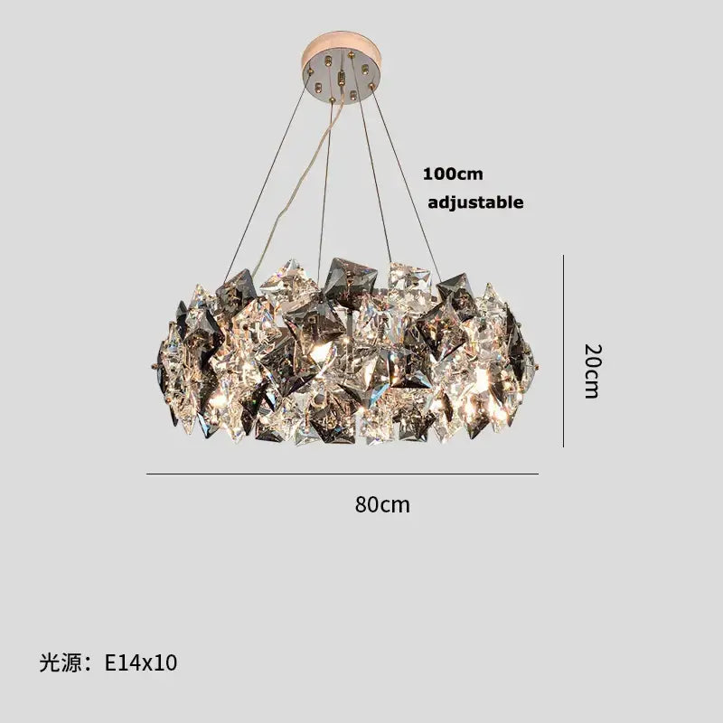 A modern gold and silver crystal dimmable led chandelier with faceted crystals in a circular design for dining room decor