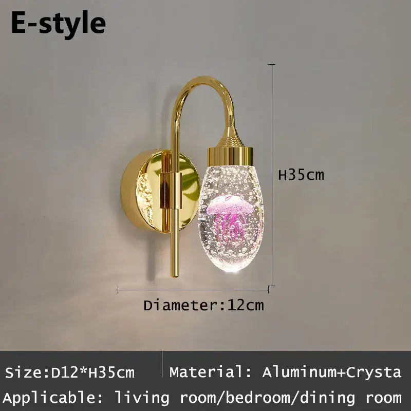 Modern gold and silver crystal led wall sconce featuring a gold-toned decorbites crystal led globe with pink jellyfish design