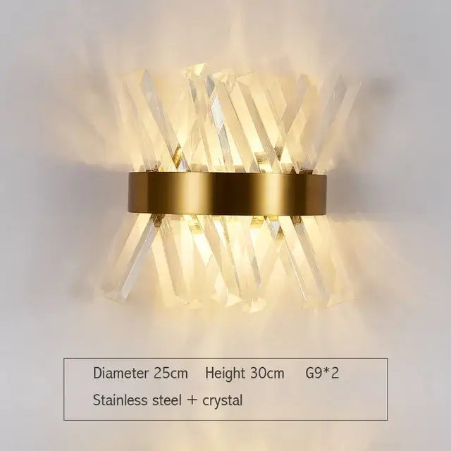 A modern gold and silver crystal wall lamp featuring a gold-toned stainless steel ring with clear crystal prisms decorbites crystal wall lamp