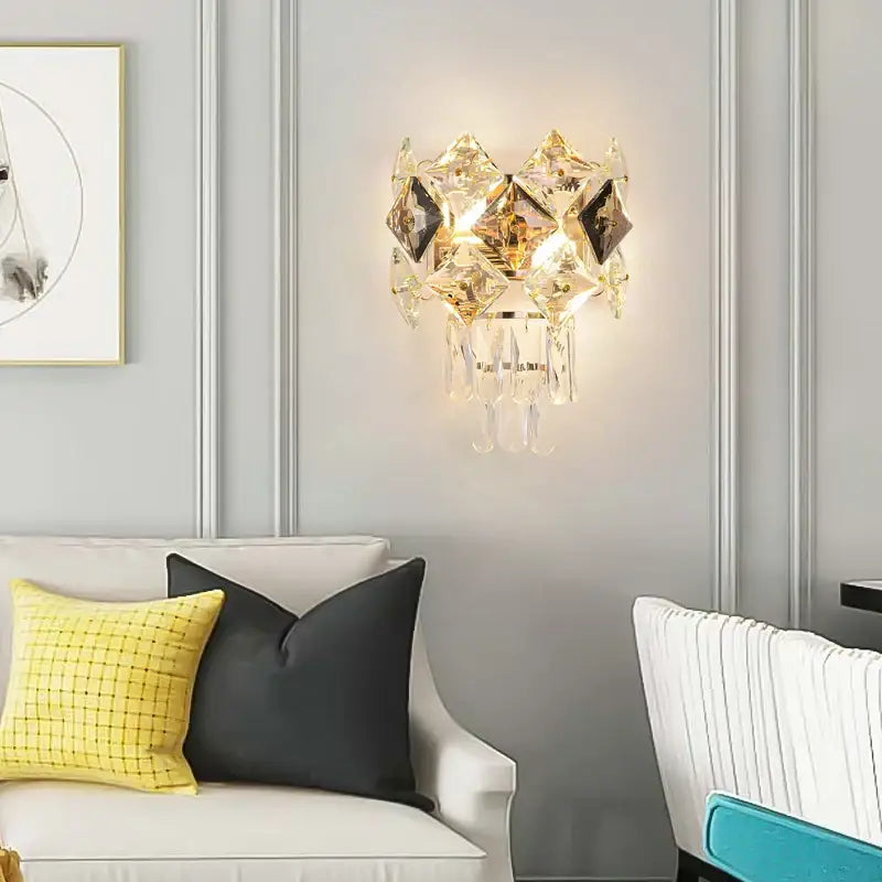 Modern gold and silver crystal wall sconce with stainless steel frame and faceted decorbites crystal gold accents