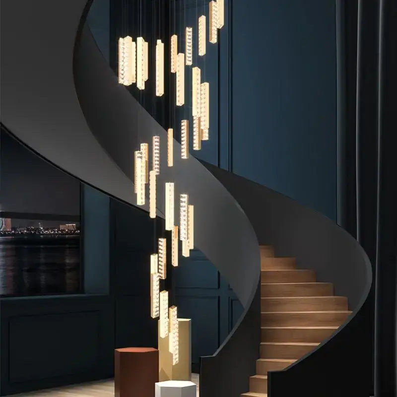 Modern gold and silver decorbites crystal chandelier with cascading rectangular lights above spiral staircase dining room light