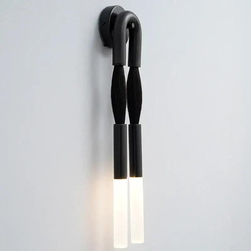 Black wall lamp with two brush-like arms and frosted glass diffusers from decorbites designer tassel collection