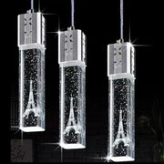 Three elegant gold and silver pendant lights with etched eiffel tower bubble crystal led designs and sparkling chambers