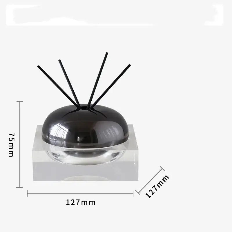Black spherical aromatherapy diffuser with clear glass base and four black reeds from decorbites golden geometry collection