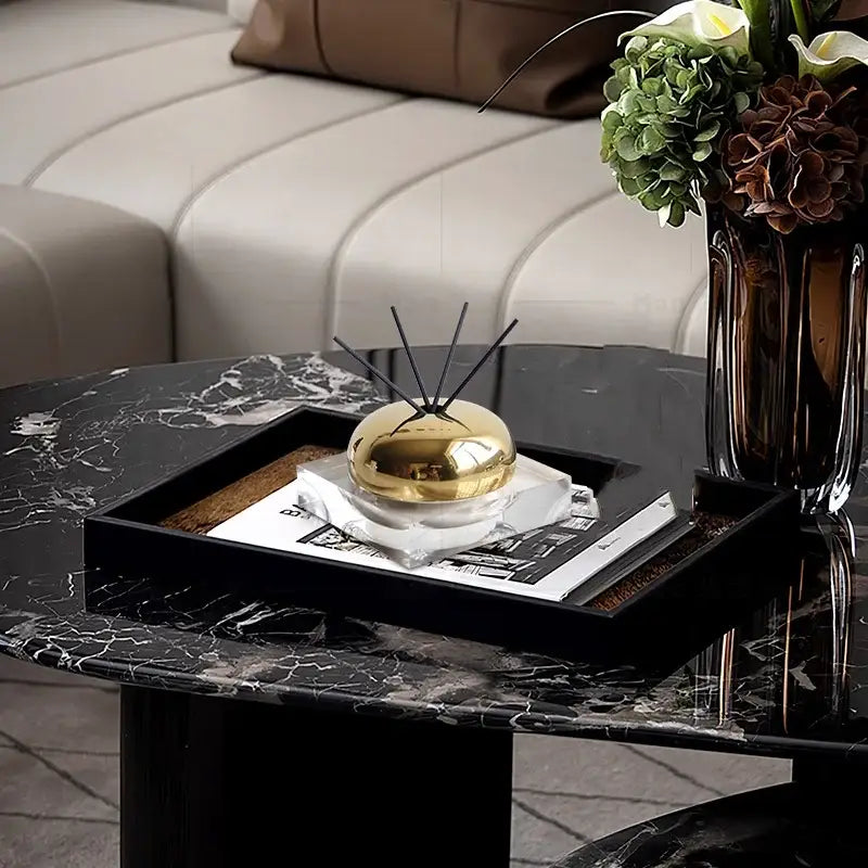 Modern gold decorbites golden geometry aromatherapy diffuser with spherical gold design and black reeds on white marble base