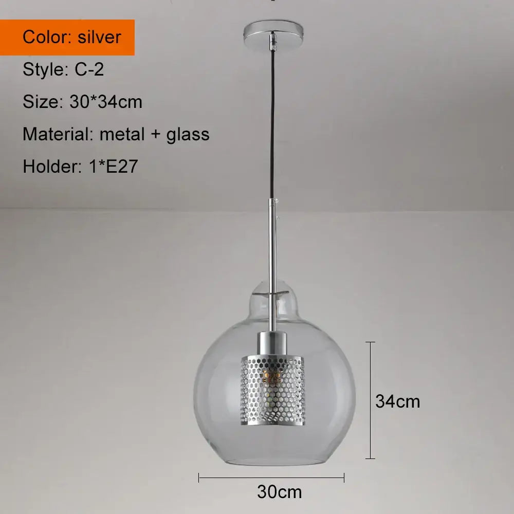 Modern gold and silver honeycomb glass pendant light with a silver perforated metal shade and clear ball glass pendant globe
