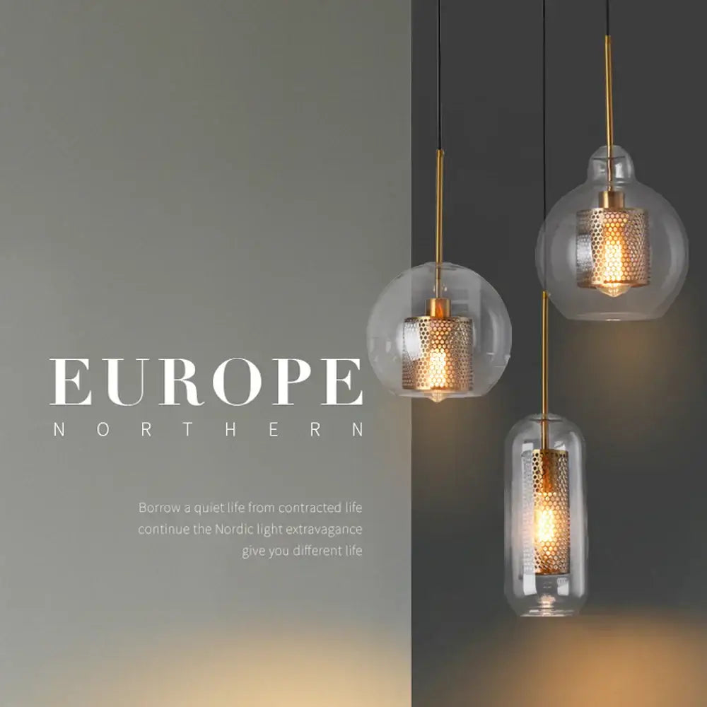 Three modern gold and silver honeycomb glass pendant lights with clear ball glass shades for kitchen use