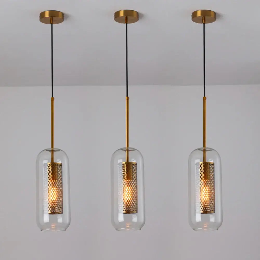 Three modern gold metal pendant lights with honeycomb-patterned clear glass shades for kitchen use