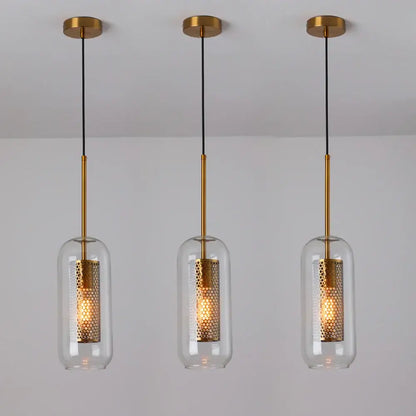 Three modern gold metal pendant lights with honeycomb-patterned clear glass shades for kitchen use