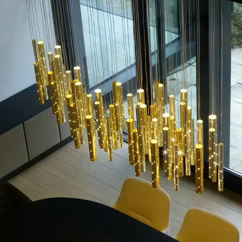 Modern gold and silver led pendant light featuring cylindrical gold fixtures with star-like bulbs for dining room decorbites gold silver chandelier
