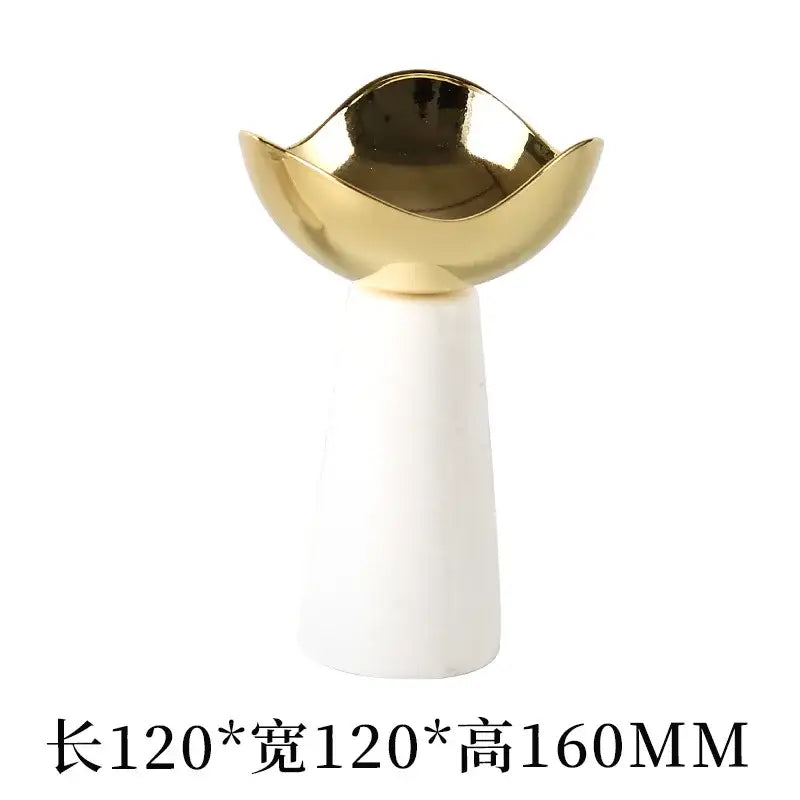 A modern dessert bowl with a glossy gold metallic top and smooth white ceramic base for decorbites golden tray use