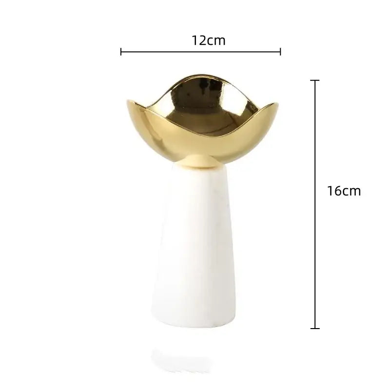 A modern dessert bowl with a glossy gold decorbites golden bowl top and smooth white marble base for dining