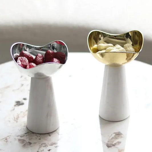 Two modern dessert bowls with heart-shaped silver and gold tops on white marble bases from decorbites golden tray