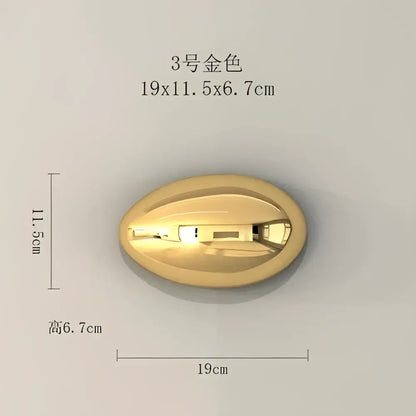 Modern gold and silver metallic oval button with engraved details used as wall hanging ornaments for living room