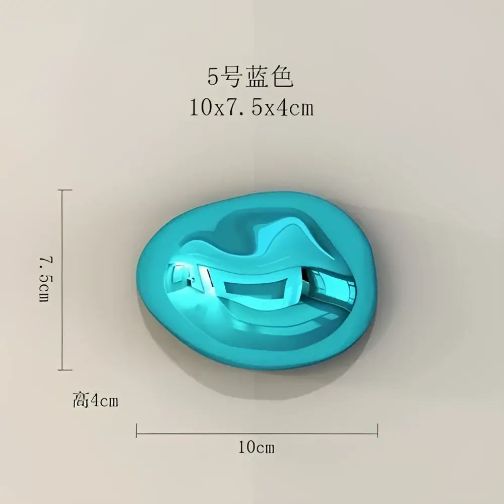 Turquoise blue glossy plastic wall hanging ornament shaped like a stylized face for modern living room decor