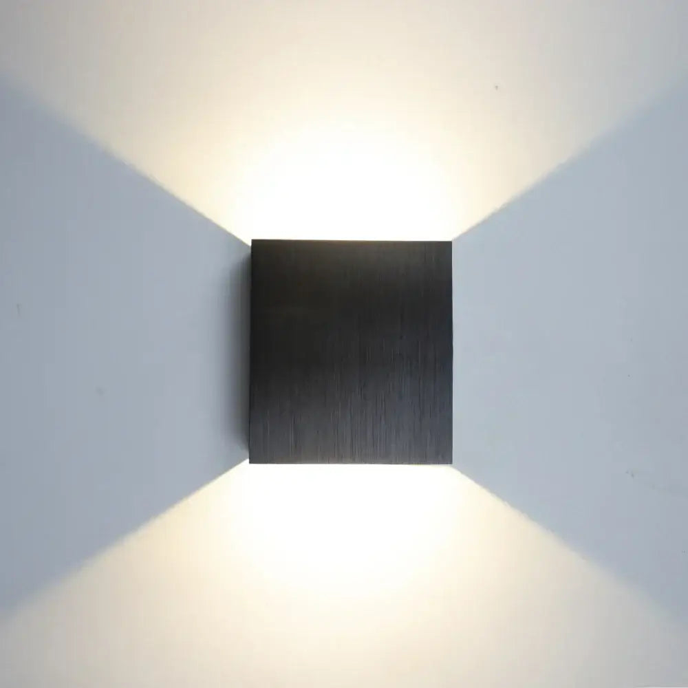 Modern gold and silver square wall lamps with brushed metal black finish emitting warm focused light for home decor