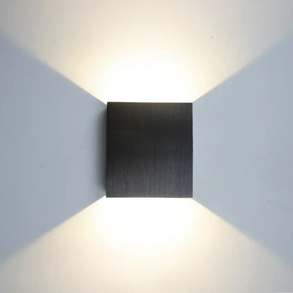 Modern gold and silver square wall lamps with brushed metal black finish emitting warm focused light for home decor