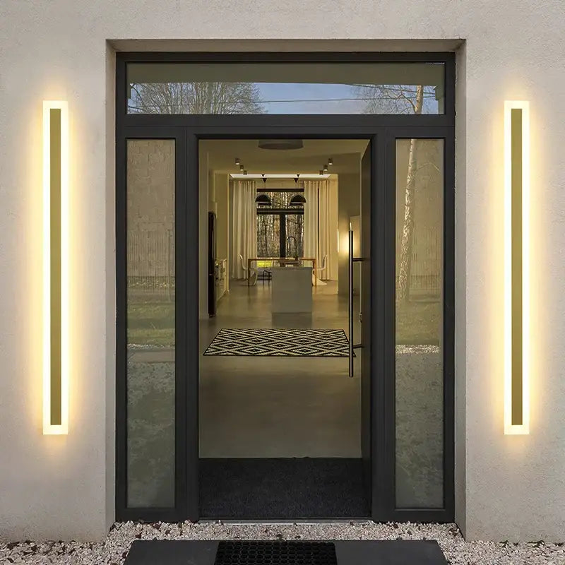 Modern gold slim led wall lamp with sleek vertical led wall lamp fixtures beside black-framed glass door outdoor decorbites wall lamp