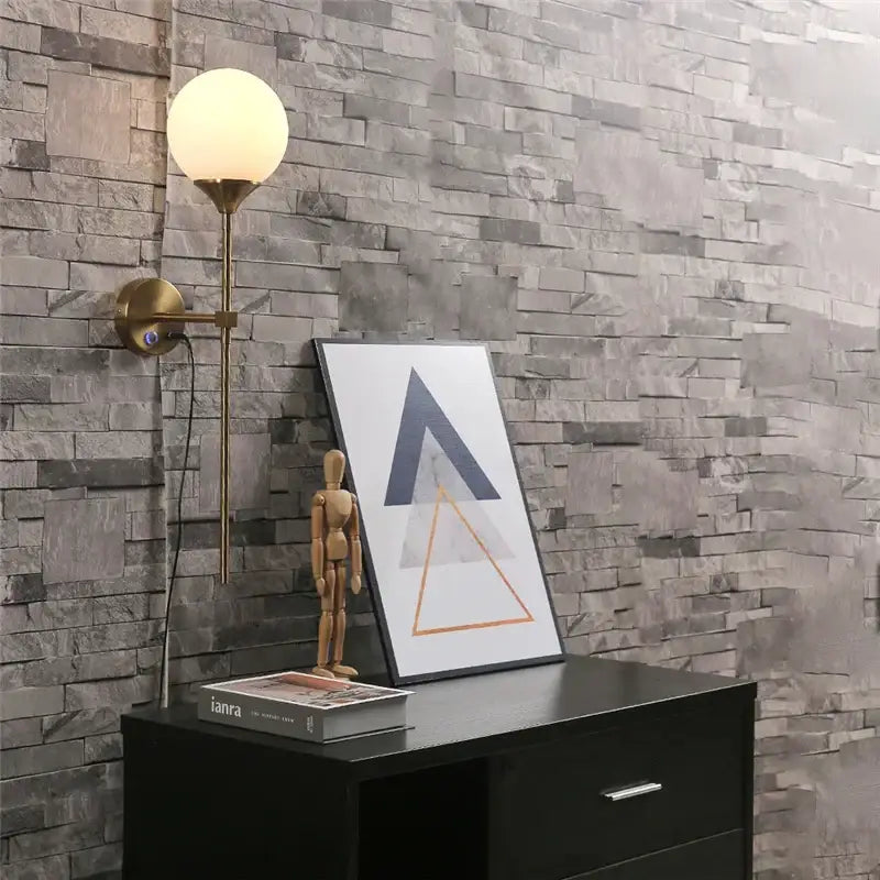 Brass-finished wall sconce with a spherical frosted glass lampshade ideal for modern decorbites glass lampshade wall lighting