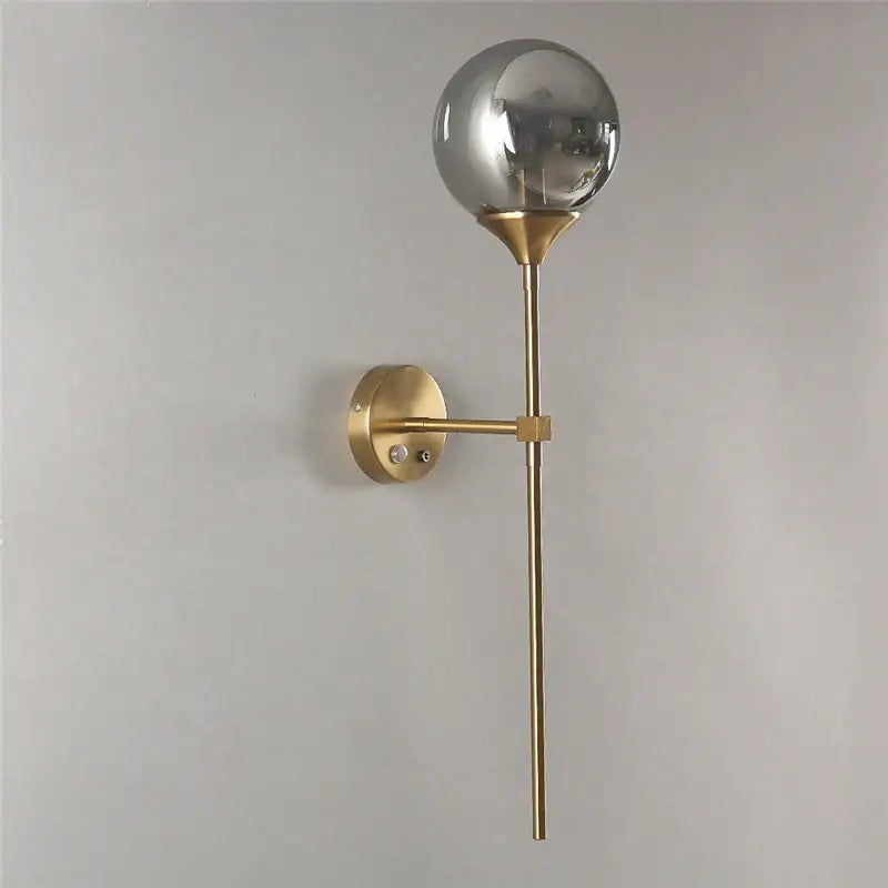 Modern gold-toned wall sconces with a spherical smoked glass lampshade for elegant bedroom lighting decorbites glass lampshade wall