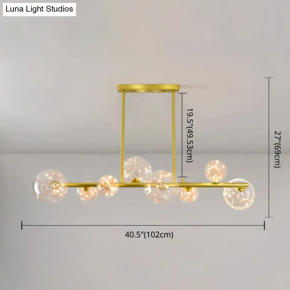 Modern gold spherical clear glass chandelier light fixture with multiple clear glass globe bulbs for dining room