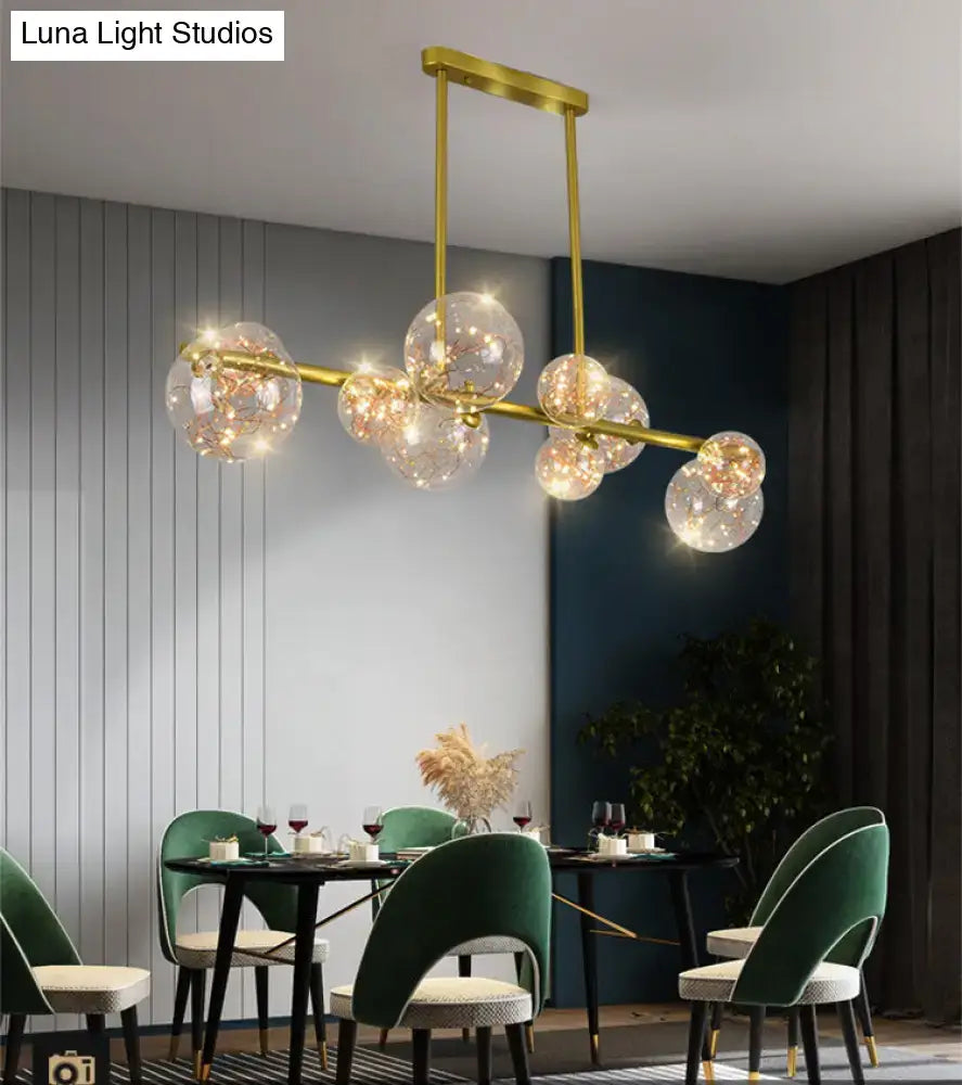 Modern gold spherical clear glass chandelier light fixture with clear glass globe bulbs for dining room use