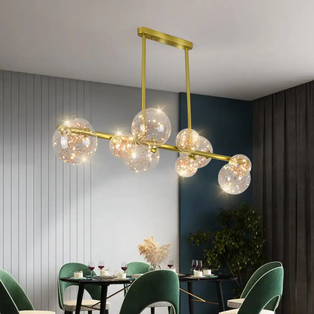 Modern gold spherical clear glass chandelier light fixture with clear glass spheres and embedded fairy lights for dining room