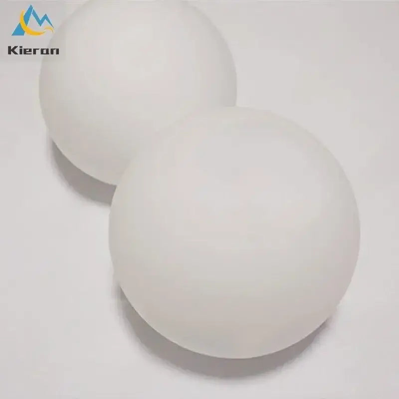 Two smooth matte white ping pong balls with subtle texture featured alongside modern gold frosted glass led wall lamps