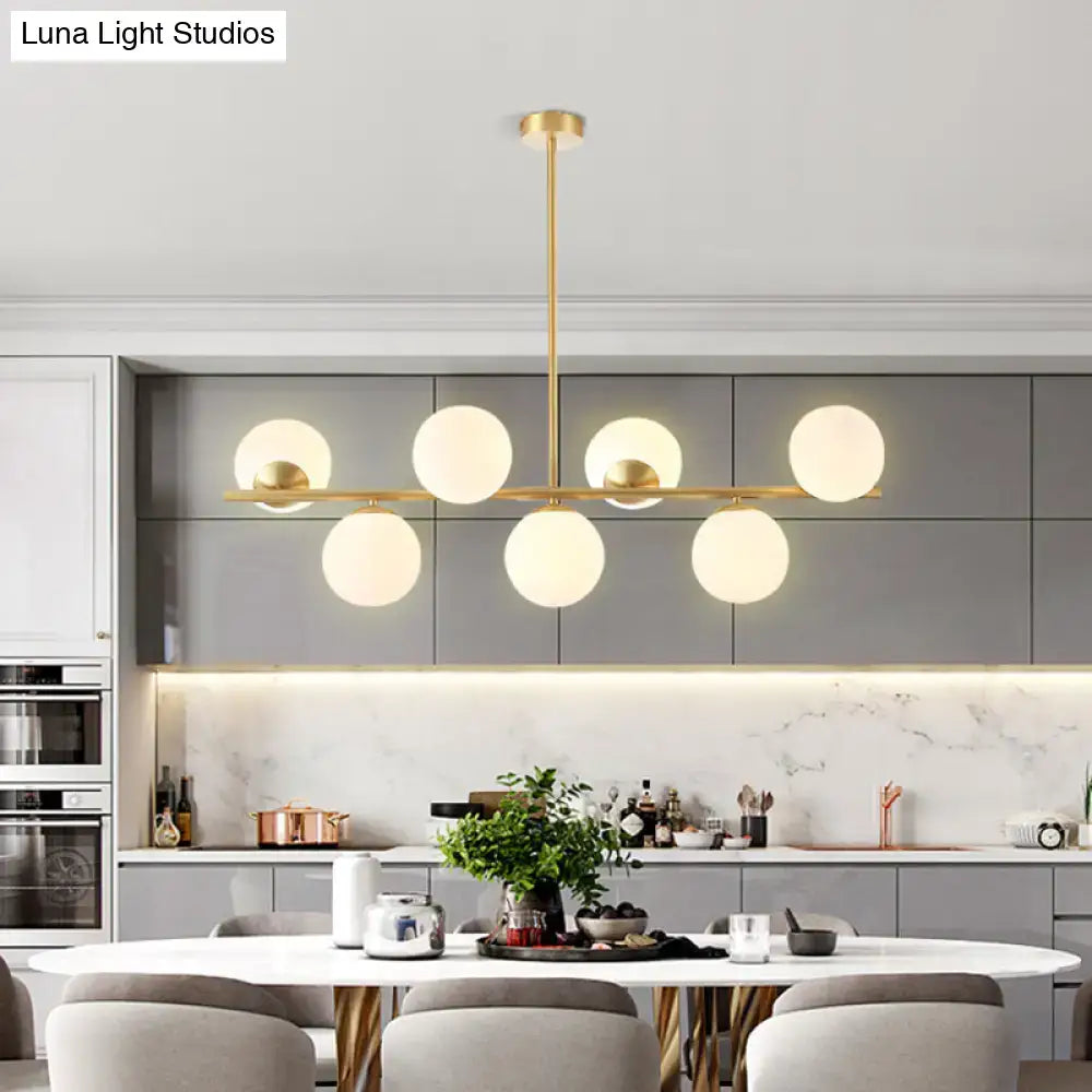 Modern brass-finished island ceiling light pendant lighting with six frosted glass light spherical shades for dining rooms