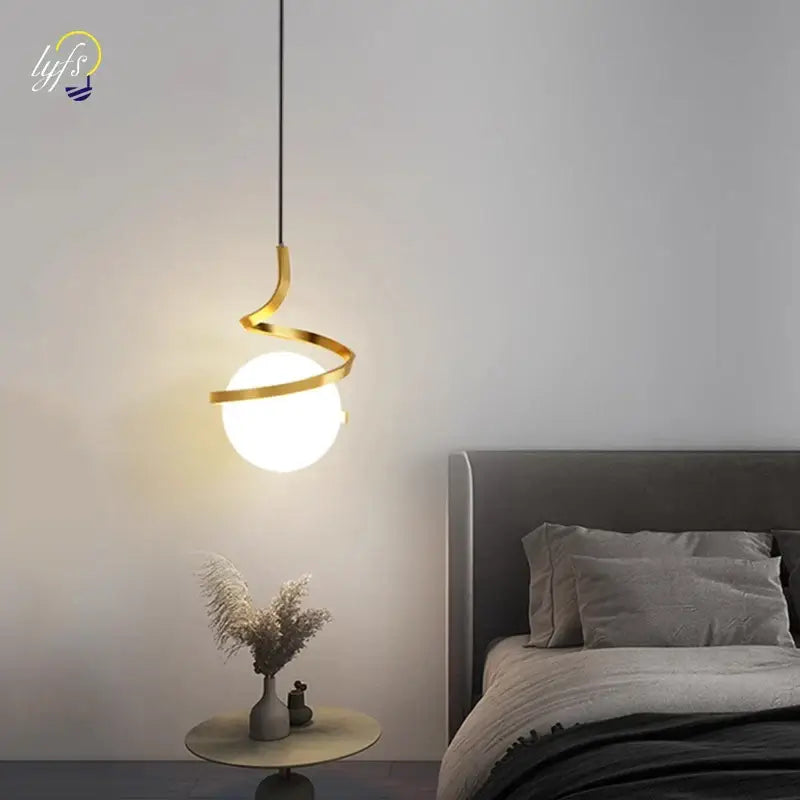 Modern gold spiral pendant light with frosted glass globe and iron finish ideal for dining room lighting color