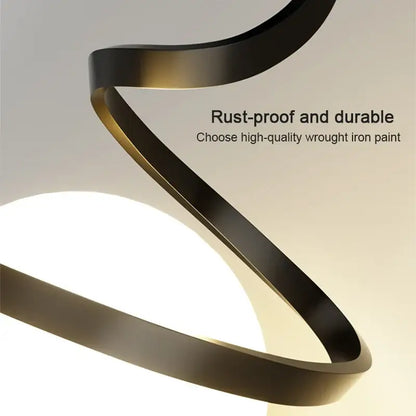 A modern pendant light with iron finish featuring a sleek black matte spiral and gold-toned inner edges for dining room