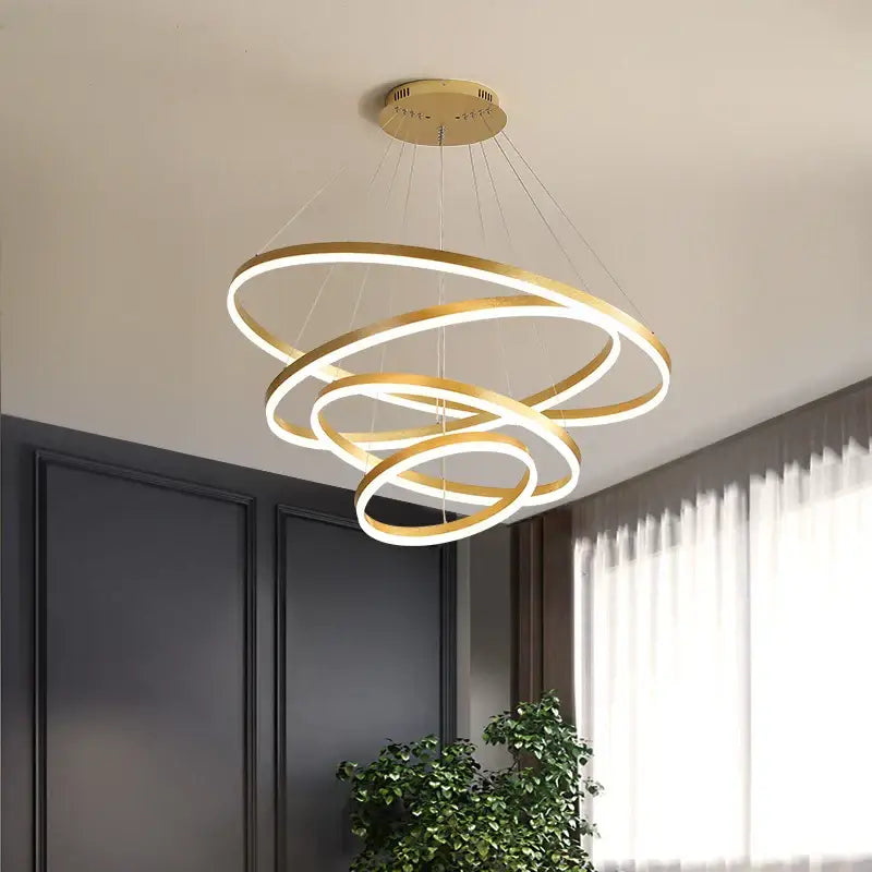 Modern gold spiral pendant light with three interlocking illuminated rings featuring decorbites black led design