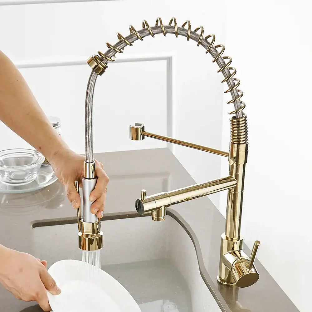 Modern gold spring spout kitchen faucet with gold-toned flexible coiled spring hose and pull out spray head by decorbites