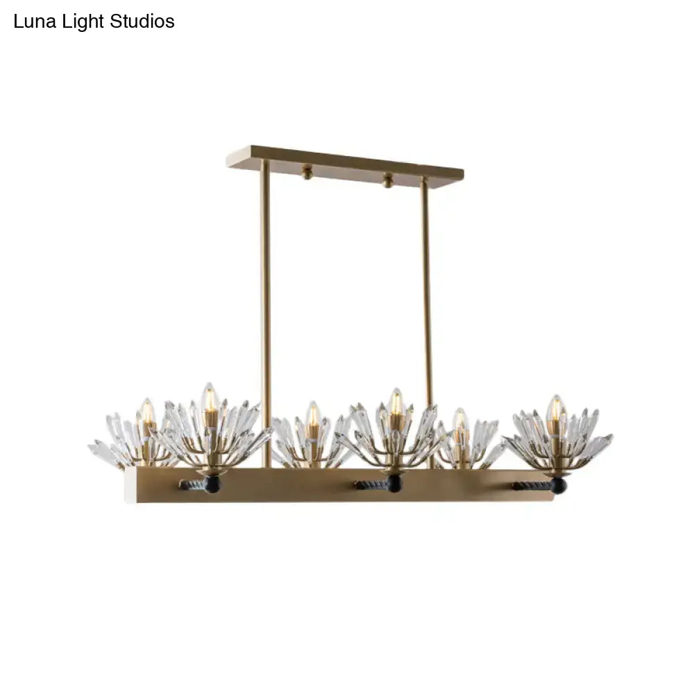 Brass-finished sputnik island light with five crystal flower-like fixtures and exposed bulbs for modern island use