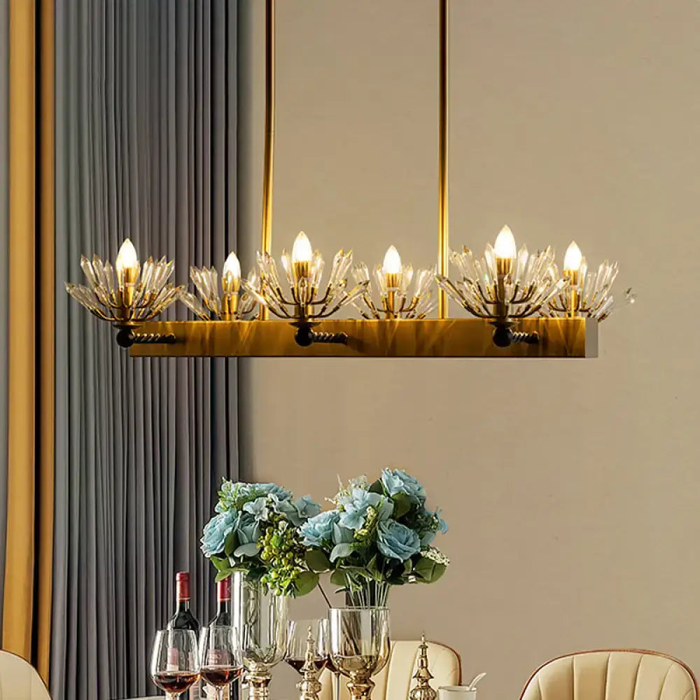 Gold-toned rectangular chandelier with crystal glass arms and illuminated bulbs for modern sputnik island light fixture