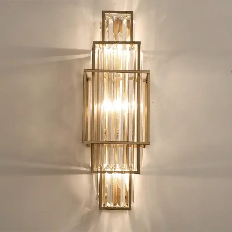 Modern gold wall lamp with stacked glass crystal rods and tiered design for luxury bedroom lighting