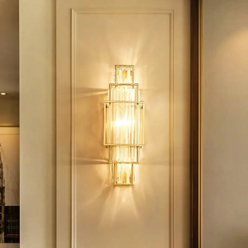 Modern gold stacked crystal wall lamp featuring rectangular glass panels for luxury bedroom lighting