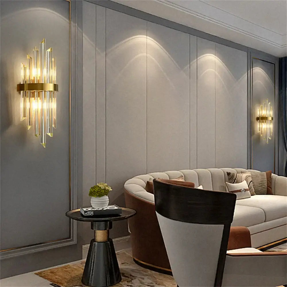 Modern gold stainless steel wall lamp with clear crystal rods and circular brass base for bedroom sconce lighting