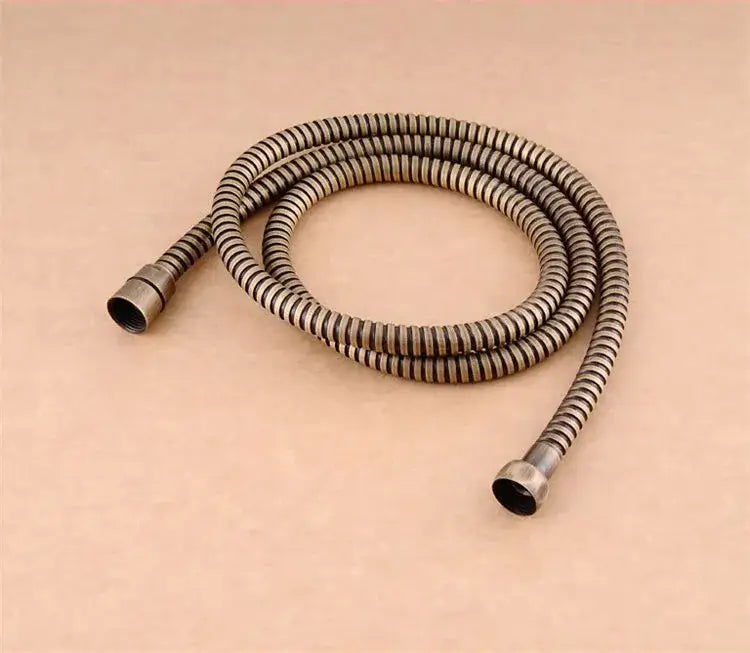 Antique brass-colored modern gold stainless steel flexible shower hose with ribbed texture and threaded ends by decorbites
