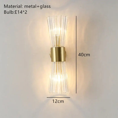 A modern gold stainless steel wall sconce with clear fluted glass panels for bedroom decorbites decor