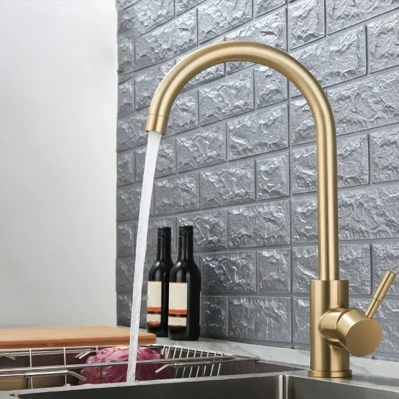A sleek modern gold stainless steel kitchen faucet with curved spout and single handle for decorbites gold stainless style