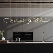 Modern gold stainless steel pendant lamp with circular interconnected rings above kitchen counter decorbites gold stainless