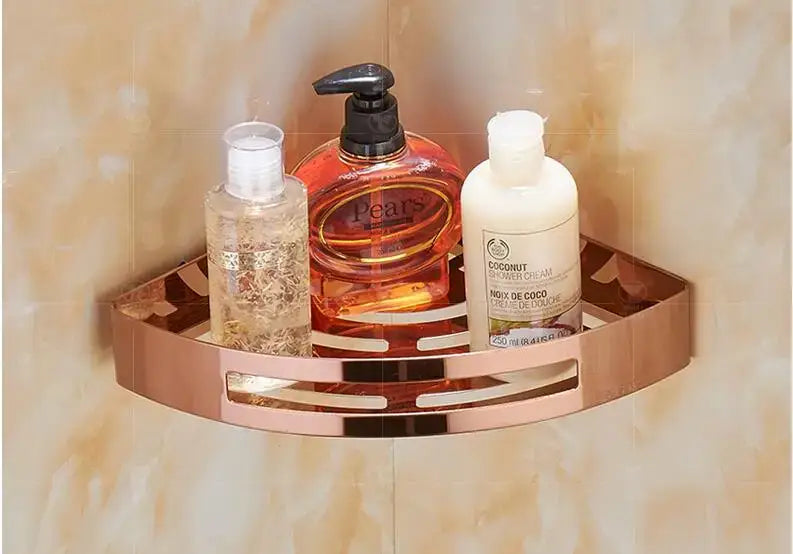 Modern gold stainless steel two tier corner shelf shower caddy in rose gold with decorative cutouts holding bathroom products