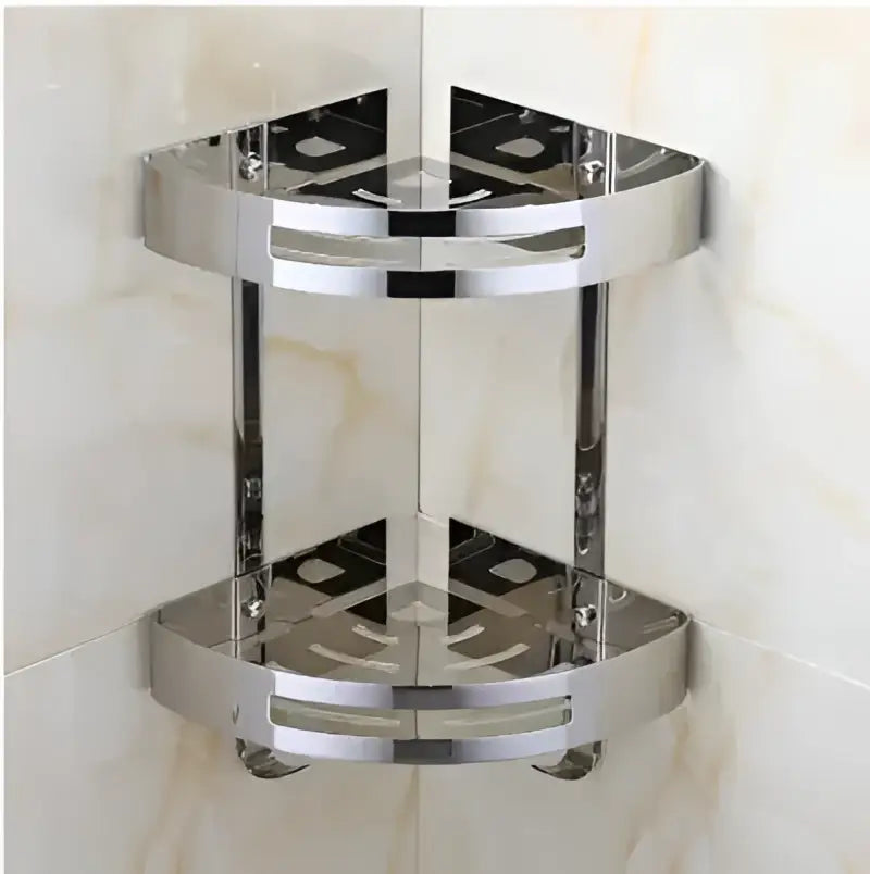 Shiny chrome-finished stainless steel double-tier corner shelf with circular cutouts for decorbites gold stainless style