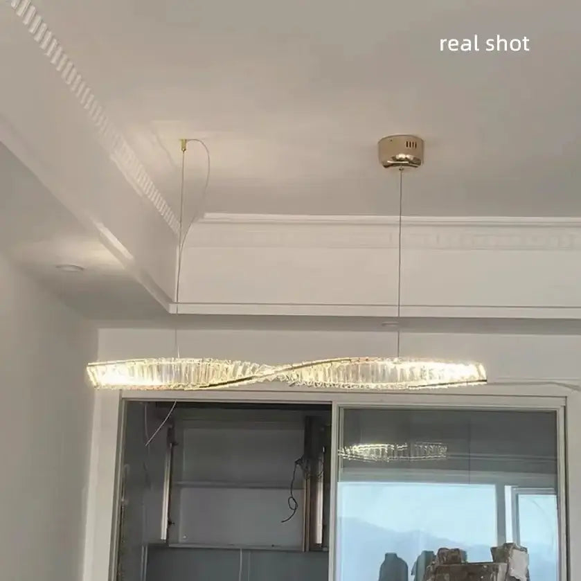 Modern gold steel led pendant light with twisted design and crystal accents for dining room decorbites gold steel