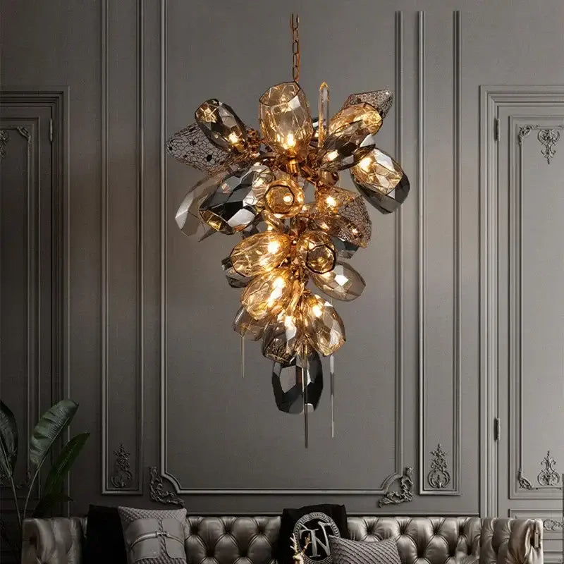 Modern gold steel led pendant lights featuring a gold-toned crystal chandelier with amber and mirrored glass elements